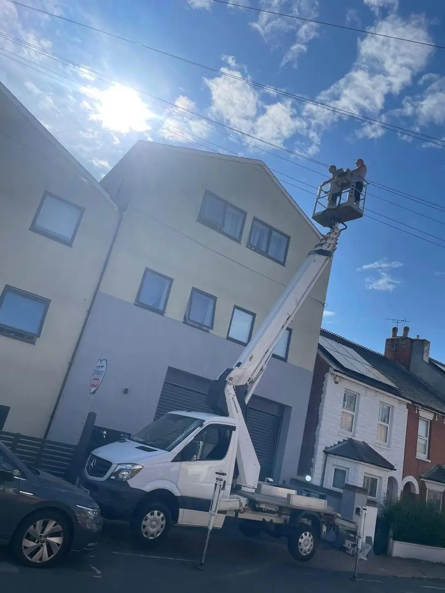 Ansco Construction team working from a cherry picker on a three storey property
